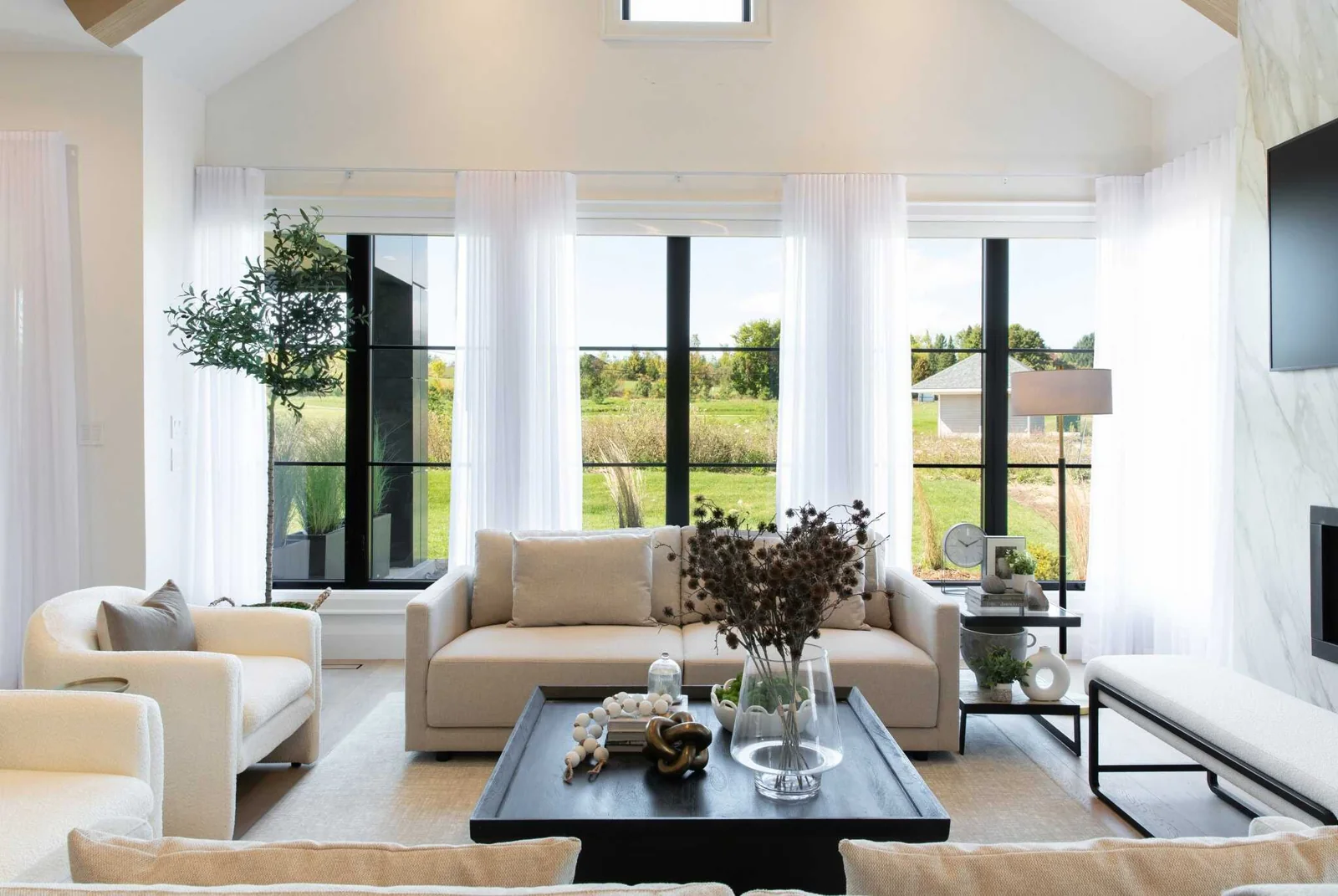 Bright living room with sheer window treatments and smart-home automation