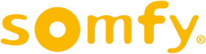 The image shows the word "somfy" in lowercase, bold, rounded yellow letters on a white background, ideal for a home design company in Miami-Dade & Broward County, FL.