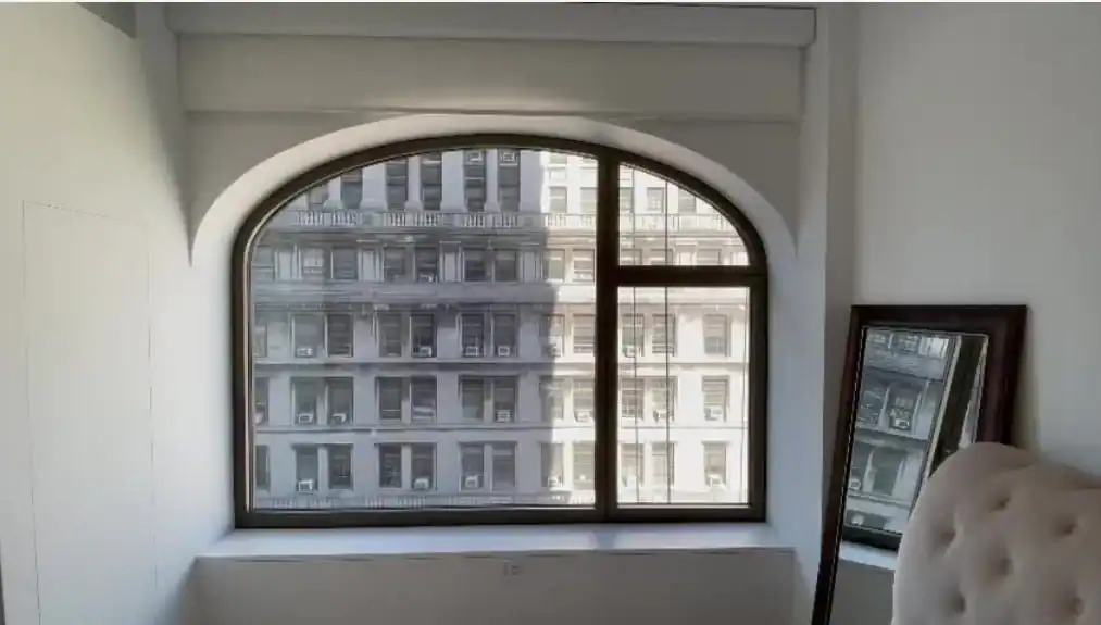 Arched window motorized shades providing sleek, modern style and sun control for homes in Broward County, Florida by Miami Design Group