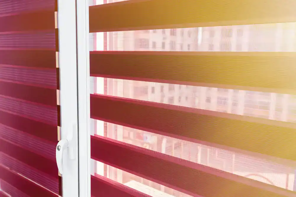 Bright red and yellow striped blinds in a modern Miami-Dade County home, adding a vibrant and stylish touch to the interior decor