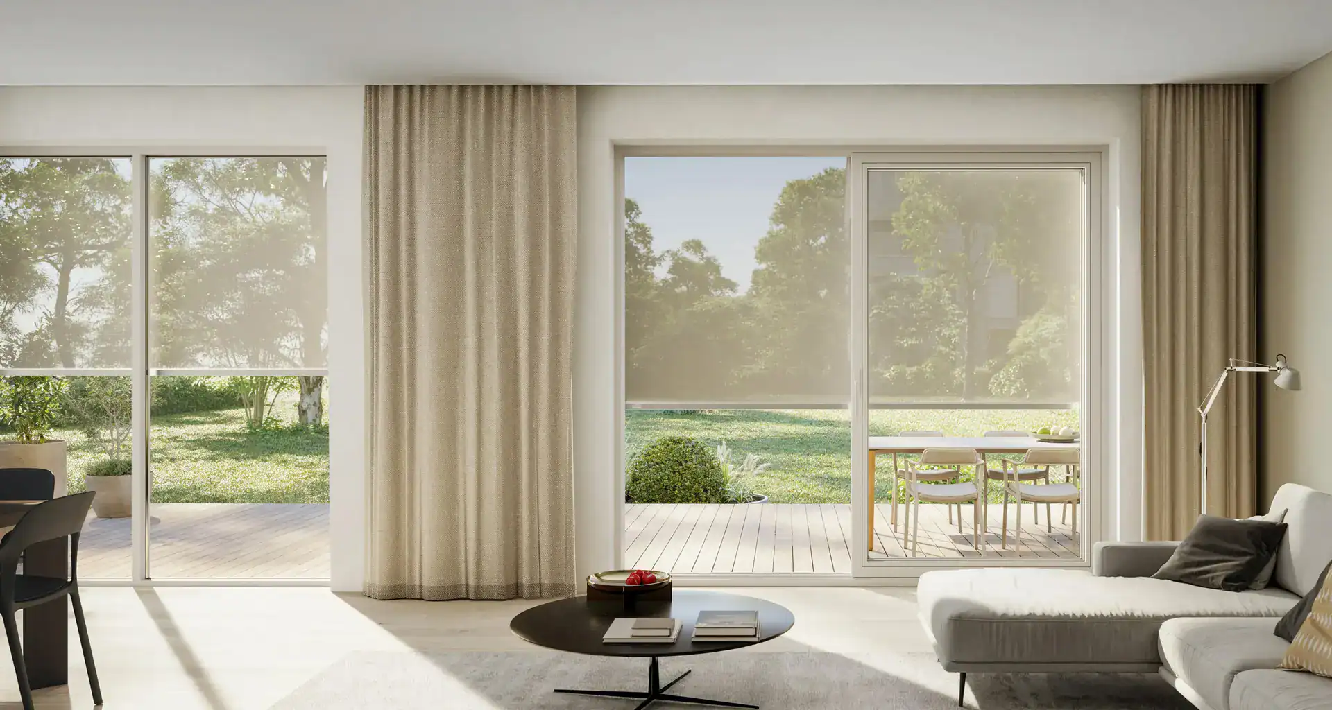 Spacious living room with glass doors leading to a garden.