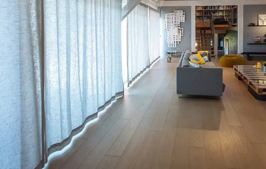 Contemporary loft with a gray sofa and wooden flooring