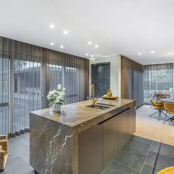 Spacious kitchen with marble island and dining area