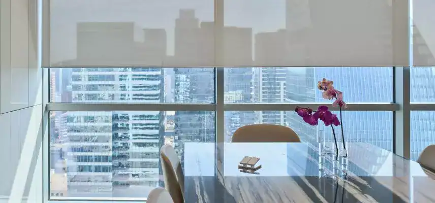 Office table with city view, marble surface, orchid decoration.