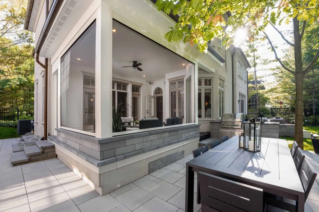 Contemporary patio featuring a screened porch and elegant seating area.